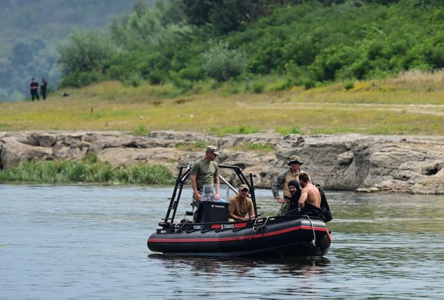 Romanian army divers observe the blast place after a controlled underwater explosion next Izvoarele village on August 3, 2026. Romanian army forces detonated an explosive load into the rock bed of Danube in Izvoarele village to help diverting a higher volume of water toward the cooling systems of the Cernavoda Nuclear Power Plant. Local authorities and plant engineers authorized the blasting operations to counteract critically low water levels caused by a prolonged summer heatwave, ensuring the continuous and safe operation of the facility's reactors. (Photo by Daniel MIHAILESCU / AFP)