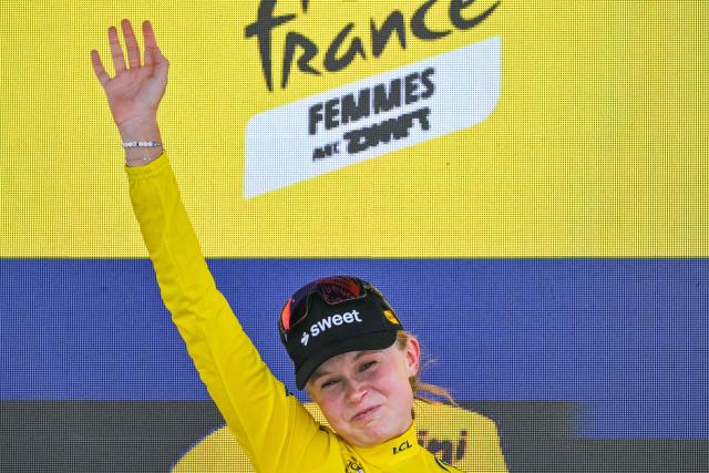 Uno-X Mobility's Norwegian rider Sigrid Ytterhus Haugset celebrates on the podium with the overall leader's yellow jersey after the 3rd (out of 9) stage of the fifth edition of the Women's Tour de France cycling race, 156.5 km from Geneva to Poligny, in Poligny, central-eastern France on August 3, 2026. (Photo by NICOLAS TUCAT / AFP)