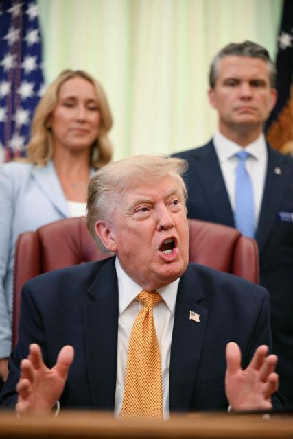US President Donald Trump speaks after signing an executive order in the Oval Office of the White House in Washington, DC, on August 3, 2026. Also pictured, Defense Secretary Pete Hegseth (R) and his wife Jennifer Hegseth (L). (Photo by Jim WATSON / AFP)