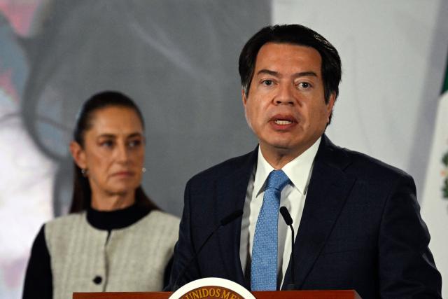 Secretary of Public Education Mario Delgado speaks next to Mexico’s President Claudia Sheinbaum during the daily press conference at the National Palace in Mexico City on August 3, 2026. (Photo by Alfredo ESTRELLA / AFP)