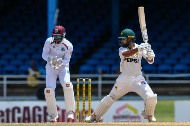 Abdullah Shafique (R) of Pakistan hits 4 and Shai Hope (L) of West Indies watch during the 2nd day of the 2nd Test match between West Indies and Pakistan at Queens Park Oval, Port of Spain, Trinidad and Tobago, on August 3, 2026. (Photo by Randy Brooks / AFP)