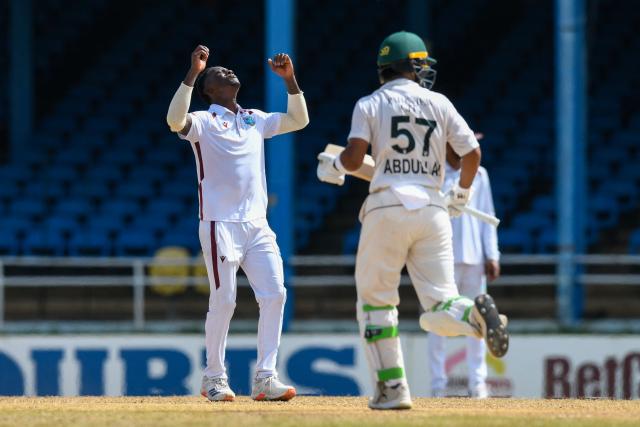 Shamar Joseph (L) of West Indies reacts after Abdullah Shafique (R) of Pakistan got runs during the second day of the second Test match between West Indies and Pakistan at Queen's Park Oval in Port of Spain, Trinidad and Tobago, on August 3, 2026. (Photo by Randy Brooks / AFP)