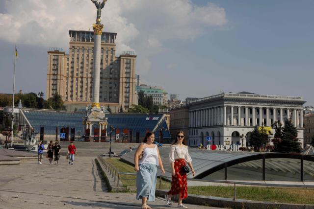 Youth walk down the main street near Independence Square in Kyiv on August 3, 2026, amid the Russian invasion of Ukraine. (Photo by Tetiana DZHAFAROVA / AFP)