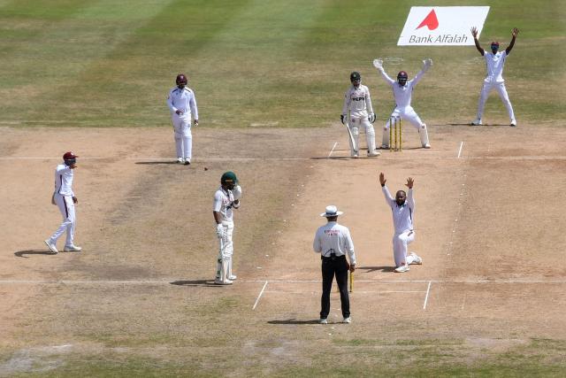 Jomel Warrican (front R) of West Indies appeals for lbw against Azan Awais (back C) of Pakistan during the second day of the second Test match between West Indies and Pakistan at Queen's Park Oval in Port of Spain, Trinidad and Tobago, on August 3, 2026. (Photo by Randy Brooks / AFP)