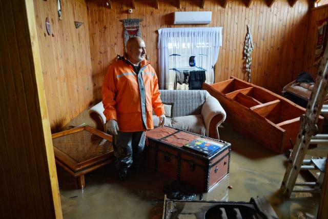 A man looks on at his flooded house in Angol, Araucania region, southern Chile, on August 3, 2026, following heavy rains. (Photo by GUILLERMO SALGADO / AFP)