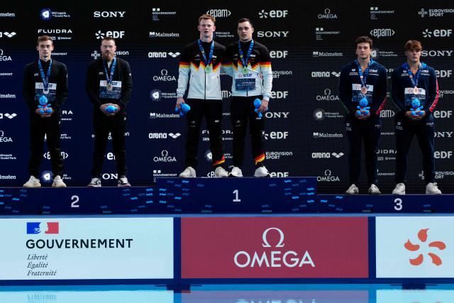 (LtoR) Silver medallists Neutral Athletes Evgenii Kuznetsov and Nikita Shleikher, Gold medallists Germany's divers Lou Noel Guy Massenberg and Jonathan Giesbert Schauer and Bronze medallists pose on the podium after the men’s 3m springboard synchro final diving event during the LEN European Aquatics Championships, at the Olympic Aquatics Centre in Saint-Denis, northeastern suburbs of Paris, on August 3, 2026. (Photo by Dimitar DILKOFF / AFP)