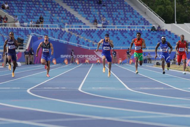 (L to R) Turk and Caicos' Kevaugh Benjamin, Venezuela's Bryant Alamo, Puerto Rico's Eloy Benitez, Grenada's Nazzio John, Virgin Islands' Rikkoi Brathwaite and Suriname's D'angelo Huisden compete in the men's 100m semifinal, heat 2, during the XXV Central American and Caribbean Games at the Felix Sanchez Olympic Stadium in Santo Domingo on August 3, 2026. (Photo by Francesco SPOTORNO / AFP)