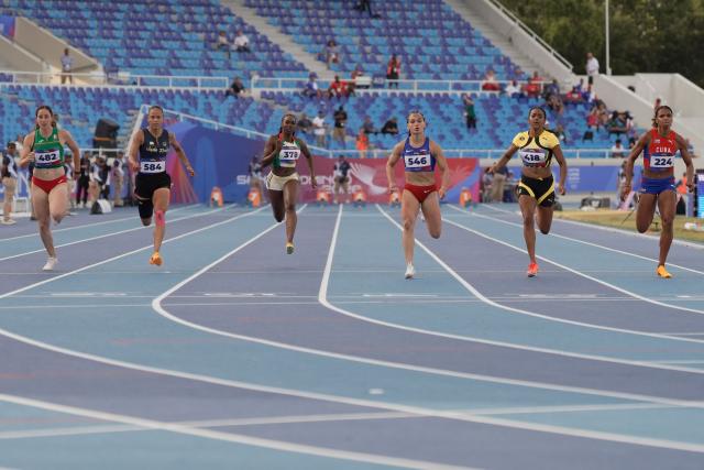 (L to R) Mexico's Cecilia Tamayo, Venezuela's Orangys Jimenez, Guyana's Juvonna Cornette, Puerto Rico's Gladymar Torres, Jamaica's Krystal Sloley and Cuba's Yarima Garcia compete in the women's 100m semifinal, heat 3, during the XXV Central American and Caribbean Games at the Felix Sanchez Olympic Stadium in Santo Domingo on August 3, 2026. (Photo by Francesco SPOTORNO / AFP)