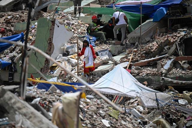 Colombian evangelical pastor Telmo Velazco walks amid rubble of buildings damaged by the June 24 earthquakes, in Caraballeda, Venezuela, on August 3, 2026. (Photo by Federico PARRA / AFP)