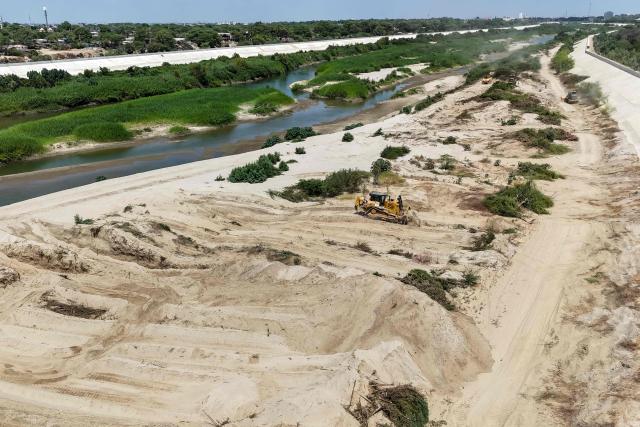 A bulldozer works during an inspection by Peru's President Keiko Fujimori of cleaning and desilting work on the Piura River in the Piura Department, Peru, on August 3, 2026. Peru's President Keiko Fujimori visited the northern part of the country on August 3, where shelters will be set up and the infrastructure of schools and hospitals will be reinforced as part of prevention efforts ahead of the El Niño weather phenomenon, which continues to intensify in the Pacific. (Photo by Ralph Zapata / AFP)