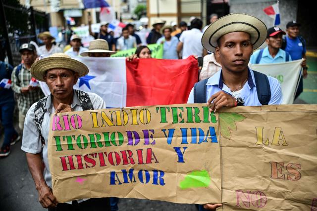 Farmers hold signs during a protest against the Rio Indio reservoir project in Panama City on August 3, 2026. The Rнo Indio Reservoir Project, promoted by the Panama Canal Authority (ACP), seeks to guarantee the supply of drinking water for more than two million people while safeguarding the Canal’s operations for the next 50 years. (Photo by MARTIN BERNETTI / AFP)