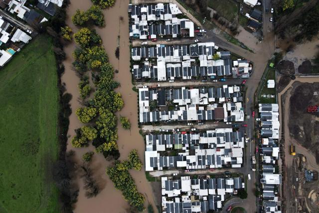 This aerial view shows flooded streets in Angol, Araucania region, Chile, on August 3, 2026, after heavy rains affected the region. (Photo by GUILLERMO SALGADO / AFP)