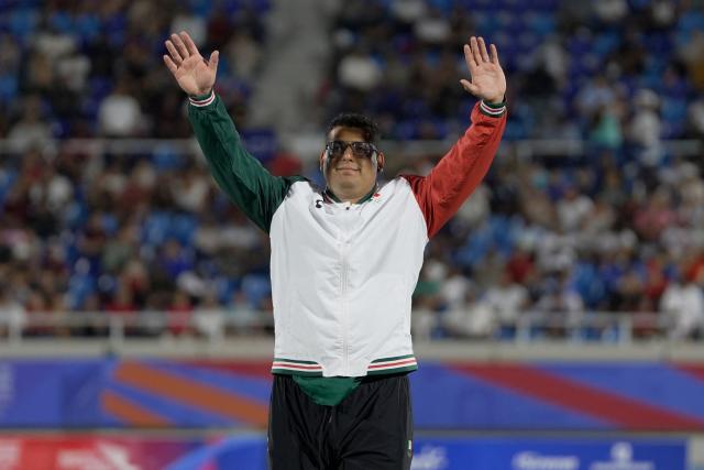 Mexico's Jairo Moran celebrates on the podium after winning the gold medals in the men's shot put final event during the XXV Central American and Caribbean Games at the Felix Sanchez Olympic Stadium in Santo Domingo on August 3, 2026. (Photo by Francesco SPOTORNO / AFP)
