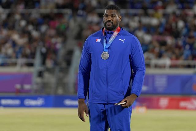 Cuba's Juan Vazquez stands on the podium after winning silver medal in the men's shot put final event during the XXV Central American and Caribbean Games at the Felix Sanchez Olympic Stadium in Santo Domingo on August 3, 2026. (Photo by Francesco SPOTORNO / AFP)