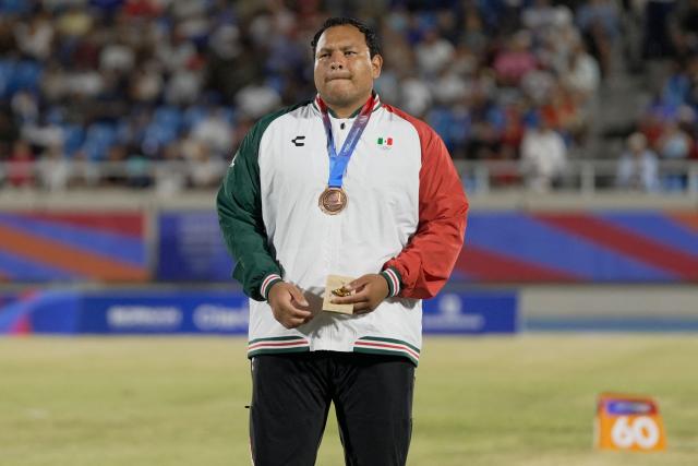 Mexico's Uziel Munoz stands on the podium after winning the bronze medal in the men's shot put final event during the XXV Central American and Caribbean Games at the Felix Sanchez Olympic Stadium in Santo Domingo on August 3, 2026. (Photo by Francesco SPOTORNO / AFP)