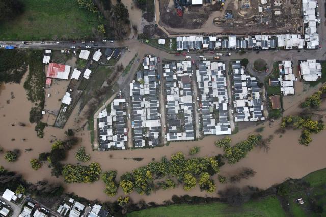 This aerial view shows flooded streets in Angol, Araucania region, Chile, on August 3, 2026, after heavy rains affected the region. (Photo by GUILLERMO SALGADO / AFP)