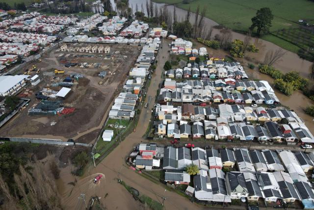 This aerial view shows flooded streets in Angol, Araucania region, Chile, on August 3, 2026, after heavy rains affected the region. (Photo by GUILLERMO SALGADO / AFP)