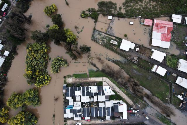 This aerial view shows flooded streets in Angol, Araucania region, Chile, on August 3, 2026, after heavy rains affected the region. (Photo by GUILLERMO SALGADO / AFP)