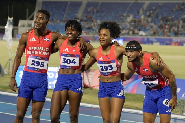 (L to R) Dominican Republic's Christopher Melenciano, Marileidy Paulino, Anabel Medina and Erick Sanchez pose after winning the 4 x 400m relay mixed final event during the XXV Central American and Caribbean Games at the Felix Sanchez Olympic Stadium in Santo Domingo on August 3, 2026. (Photo by Francesco SPOTORNO / AFP)