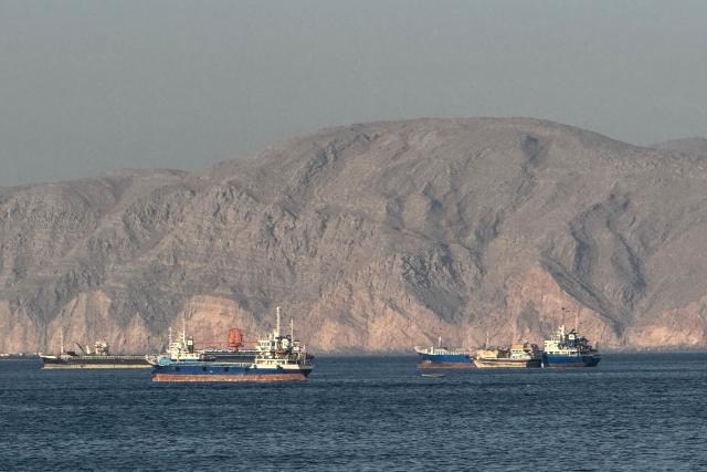(FILES) Vessels are seen anchored in the Strait of Hormuz, off the port city of Khasab on Omans northern Musandam Peninsula on May 17, 2026. For 115 days, captain Mohammad Shafiqul Islam was stranded in the high seas of the Gulf, watching missiles light up the night sky and rationing food and water for his crew. "I tried to stay calm because I was responsible for 31 lives, a ship worth $40 million and cargo valued at $8.2 million," the 51-year-old Bangladeshi mariner told AFP, back home after the ordeal. (Photo by AFP) / 