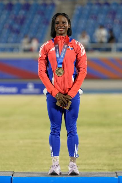 Dominican Republic's Liranyi Alonso poses on the podium after winning the gold medal in the women's 100m final during the XXV Central American and Caribbean Games at the Felix Sanchez Olympic Stadium in Santo Domingo on August 3, 2026. (Photo by Francesco SPOTORNO / AFP)