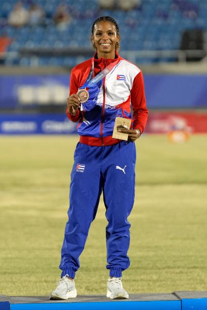 Cuba's Yarima Garcia poses on the podium after winning the bronze medal in the women's 100m final during the XXV Central American and Caribbean Games at the Felix Sanchez Olympic Stadium in Santo Domingo on August 3, 2026. (Photo by Francesco SPOTORNO / AFP)