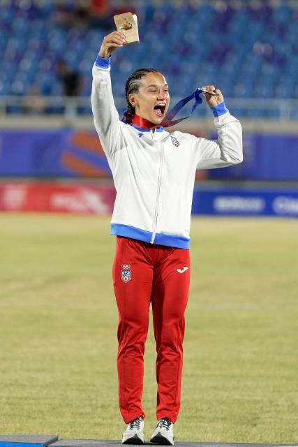 Puerto Rico's Gladymar Torres celebrates on the podium after winning the silver medal in the women's 100m final during the XXV Central American and Caribbean Games at the Felix Sanchez Olympic Stadium in Santo Domingo on August 3, 2026. (Photo by Francesco SPOTORNO / AFP)