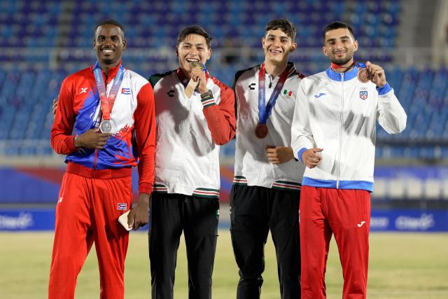 Mexico's Erick Portillo (2nd L), Cuba's Luis Zayas (L), Mexico's Jair Portillo (2nd R) and Puerto Rico's Marcus Gelpi pose on the podium after winning the gold, silver and bronze medals, respectively, in the men's high jump final during the XXV Central American and Caribbean Games at the Felix Sanchez Olympic Stadium in Santo Domingo on August 3, 2026. (Photo by Francesco SPOTORNO / AFP)
