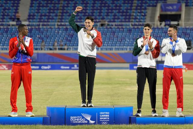 Mexico's Erick Portillo (2nd L), Cuba's Luis Zayas (L), Mexico's Jair Portillo (2nd R) and Puerto Rico's Marcus Gelpi pose on the podium after winning the gold, silver and bronze medals, respectively, in the men's high jump final during the XXV Central American and Caribbean Games at the Felix Sanchez Olympic Stadium in Santo Domingo on August 3, 2026. (Photo by Francesco SPOTORNO / AFP)