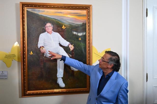 Colombia's President Gustavo Petro points at a portrait of himself painted by Colombian artist Jaime Rojas during its unveiling at the Casa de Narino Presidential Palace in Bogota on August 3, 2026. (Photo by Raul ARBOLEDA / AFP)