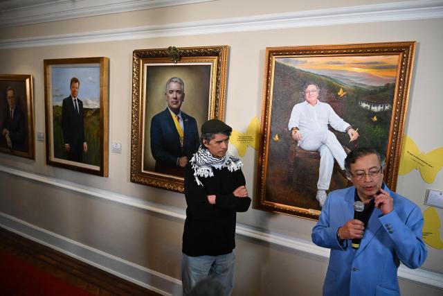 Colombia's President Gustavo Petro (R) speaks next to a portrait of himself painted by Colombian artist Jaime Rojas (L) during its unveiling at the Casa de Narino Presidential Palace in Bogota on August 3, 2026. (Photo by Raul ARBOLEDA / AFP)
