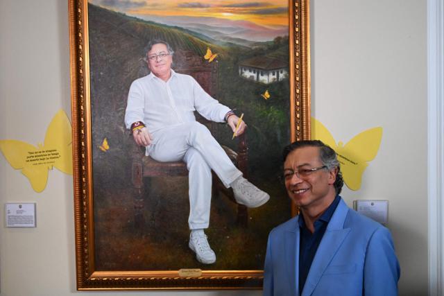 Colombia's President Gustavo Petro poses next to a portrait of himself painted by Colombian artist Jaime Rojas during its unveiling at the Casa de Narino Presidential Palace in Bogota on August 3, 2026. (Photo by Raul ARBOLEDA / AFP)