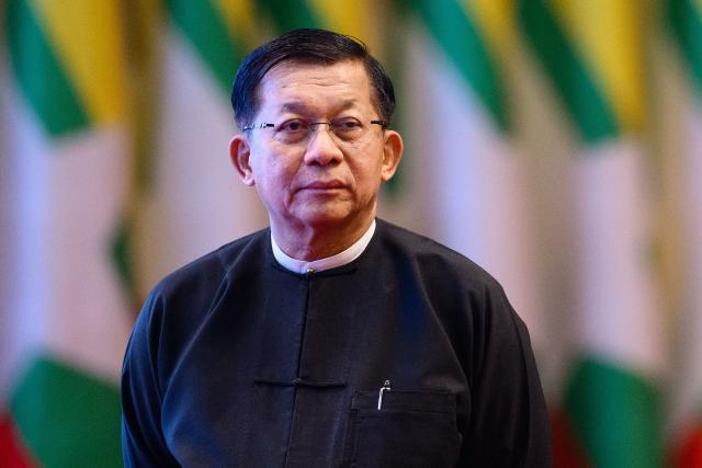 (FILES) Myanmar's then-military chief Min Aung Hlaing looks on after delivering a speech during a memorial event at the Myanmar International Convention Centre (MICC) in Naypyidaw on March 28, 2026, to mark the first anniversary since a 7.7-magnitude earthquake. Myanmar's ex-junta chief Min Aung Hlaing is expected in Thailand on August 6, making his first trip there since becoming civilian leader as he seeks a return to the diplomatic fold for his pariah state. (Photo by ANTHONY WALLACE / AFP)