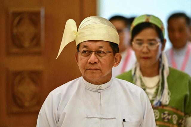 (FILES) Myanmar's President Min Aung Hlaing arrives to attend his sworn-in ceremony during a session of the Pyidaungsu Hluttaw (Union Parliament) in Naypyidaw on April 10, 2026. Myanmar's ex-junta chief Min Aung Hlaing is expected in Thailand on August 6, making his first trip there since becoming civilian leader as he seeks a return to the diplomatic fold for his pariah state. (Photo by Sai Aung MAIN / AFP)