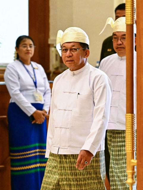 (FILES) Myanmar's President Min Aung Hlaing arrives to attend his sworn-in ceremony during a session of the Pyidaungsu Hluttaw (Union Parliament) in Naypyidaw on April 10, 2026. Myanmar's ex-junta chief Min Aung Hlaing is expected in Thailand on August 6, making his first trip there since becoming civilian leader as he seeks a return to the diplomatic fold for his pariah state. (Photo by Sai Aung MAIN / AFP)