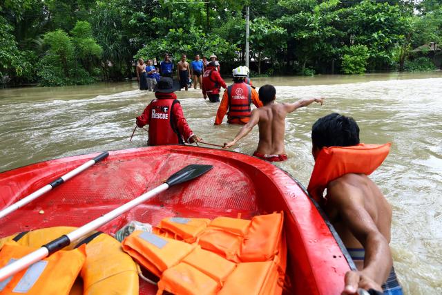 Rescue workers help residents affected by flooding in Lemyethna in Myanmar's Irrawaddy Delta region on August 3, 2026. (Photo by AFP)