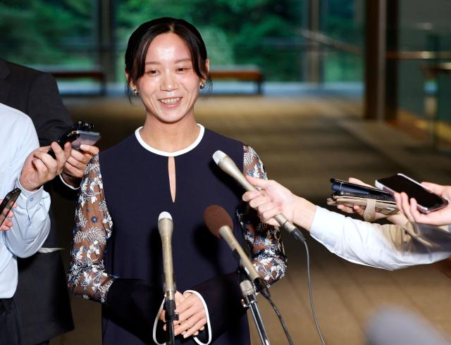 Japanese speed skater Miho Takagi speaks to reporters after receiving the People's Honor Award at the prime minister's office in Tokyo on August 4, 2026. (Photo by Franck ROBICHON / POOL / AFP)