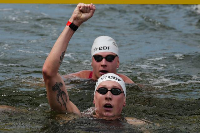 Germany's swimmer Florian Wellbrock celebrates winning the men's 10km open water swimming event during the LEN European Aquatics Championships, in the Seine River in Paris, on August 4, 2026. (Photo by Dimitar DILKOFF / AFP)