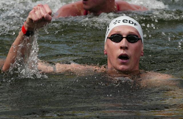 Germany's swimmer Florian Wellbrock celebrates winning the men's 10km open water swimming event during the LEN European Aquatics Championships, in the Seine River in Paris, on August 4, 2026. (Photo by Dimitar DILKOFF / AFP)