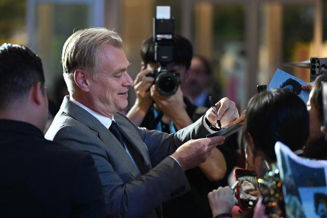 British-American filmmaker Christopher Nolan signs autographs at a red carpet event for the film 'The Odyssey' in Seoul on August 4, 2026, ahead of its opening on August 5. (Photo by GREG BAKER / AFP)