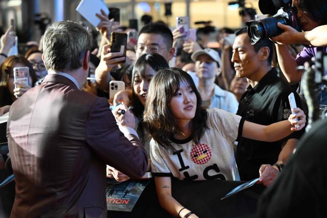 A fan takes a selfie as US actor Matt Damon (L) signs autographs at a red carpet event for the film 'The Odyssey' in Seoul on August 4, 2026, ahead of its opening on August 5. (Photo by GREG BAKER / AFP)