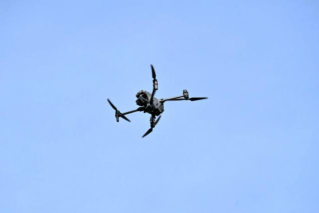 View of a police drone during an operation near Las Cuadras Market in southern Quito, on August 4, 2026. The Ecuadorian government deployed on August 3, 2026, 4,000 police officers and military personnel in Quito to step up security in the capital, following the discovery of a decapitated body and reports of people going missing in recent weeks. (Photo by Rodrigo BUENDIA / AFP)