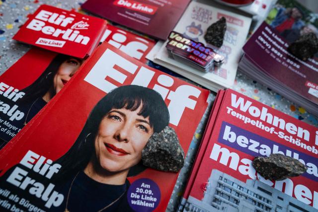 Campaign material featuring a portrait of the Left Party's (Die Linke) main candidate in upcoming regional elections in Berlin Elif Eralp is laid out in front of a cafe during a campaign stop in Berlin's Schoeneberg district on August 4, 2026. Berlin goes to the polls on September 20, 2026. (Photo by John MACDOUGALL / AFP)