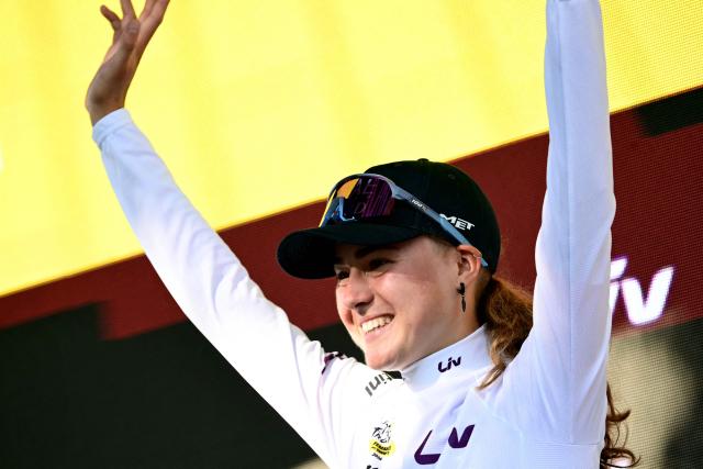 UAE Team ADQ's Spanish rider Paula Blasi celebrates on the podium with the best young rider's white jersey after the individual time-trial in the 4th (out of 9) stage of the fifth edition of the Women's Tour de France cycling race, 21 km time trial between Gevrey-Chambertin and Dijon, in Dijon, eastern France on August 4, 2026. (Photo by NICOLAS TUCAT / AFP)