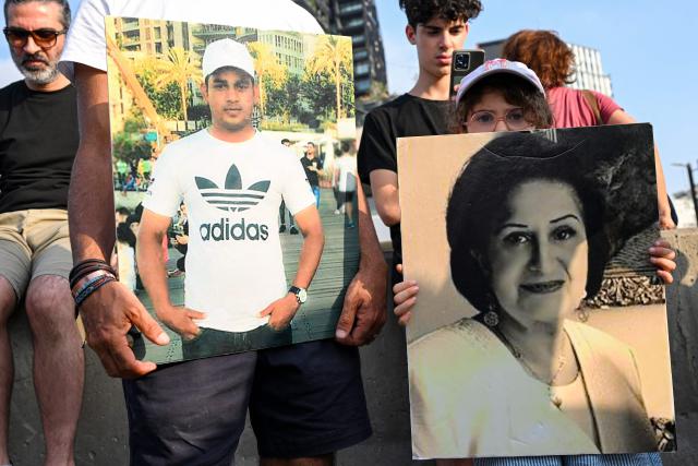 Family members and relatives of the victims of the 2020 Beirut port explosion march with their pictures on the sixth anniversary of the incident near the port area in Beirut on August 4, 2026. The massive Beirut port explosion on August 4, 2020, killed more than 220 people, injured more that 6,500 and damaged swathes of the capital. Lebanese authorities have said the explosion was triggered by a fire in a warehouse where tonnes of ammonium nitrate fertiliser had been stored haphazardly for years, despite repeated warnings to senior officials. (Photo by Joseph EID / AFP)