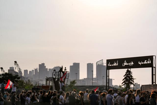 Family members and relatives of the victims of the 2020 Beirut port explosion gather for an event commemorating the sixth anniversary of the incident outside the port area in Beirut on August 4, 2026. The massive Beirut port explosion on August 4, 2020, killed more than 220 people, injured more that 6,500 and damaged swathes of the capital. Lebanese authorities have said the explosion was triggered by a fire in a warehouse where tonnes of ammonium nitrate fertiliser had been stored haphazardly for years, despite repeated warnings to senior officials. (Photo by Joseph EID / AFP)