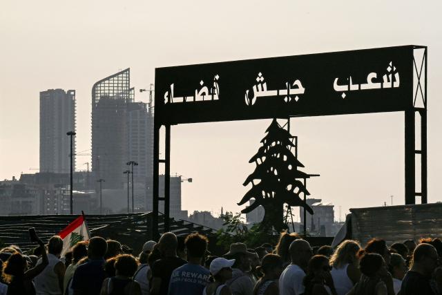 Family members and relatives of the victims of the 2020 Beirut port explosion gather for an event commemorating the sixth anniversary of the incident outside the port area in Beirut on August 4, 2026. The massive Beirut port explosion on August 4, 2020, killed more than 220 people, injured more that 6,500 and damaged swathes of the capital. Lebanese authorities have said the explosion was triggered by a fire in a warehouse where tonnes of ammonium nitrate fertiliser had been stored haphazardly for years, despite repeated warnings to senior officials. (Photo by Joseph EID / AFP)