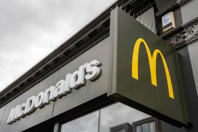 (FILES) Signage is pictured above a branch of US fast food chain McDonald’s in Balham, south London on September 27, 2025. McDonald's reported slower sales growth in the US market in the second quarter as executives blamed too many simultaneous promotional offers, including a World Cup campaign that disappointed. The fast-food chain said it remains committed to a value-oriented menu that has resonated in recent years amid inflation-weary consumers in its home market and overseas. (Photo by Niklas HALLE'N / AFP)