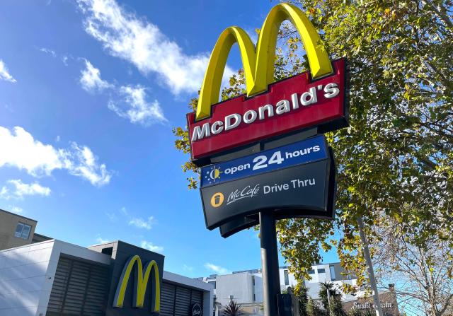 (FILES) A McDonald's emblem adorns the front of one of their outlets in Sydney on July 4, 2024. McDonald's reported slower sales growth in the US market in the second quarter as executives blamed too many simultaneous promotional offers, including a World Cup campaign that disappointed. The fast-food chain said it remains committed to a value-oriented menu that has resonated in recent years amid inflation-weary consumers in its home market and overseas. (Photo by DAVID GRAY / AFP)