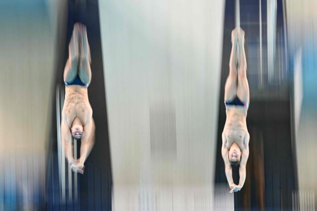 Italy's diver Simone Conte and Italy's diver Raffaele Pelligra compete in the men’s 10m platform synchro diving final event during the LEN European Aquatics Championships, at the Olympic Aquatics Centre in Saint-Denis, northeastern suburbs of Paris, on August 4, 2026. (Photo by SEBASTIEN BOZON / AFP)